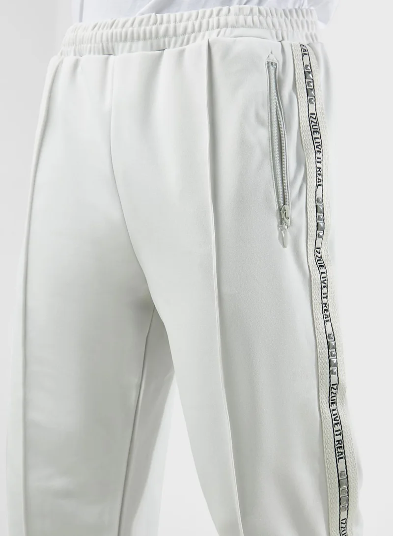 izzue Studs Tape Logo Sweatpants