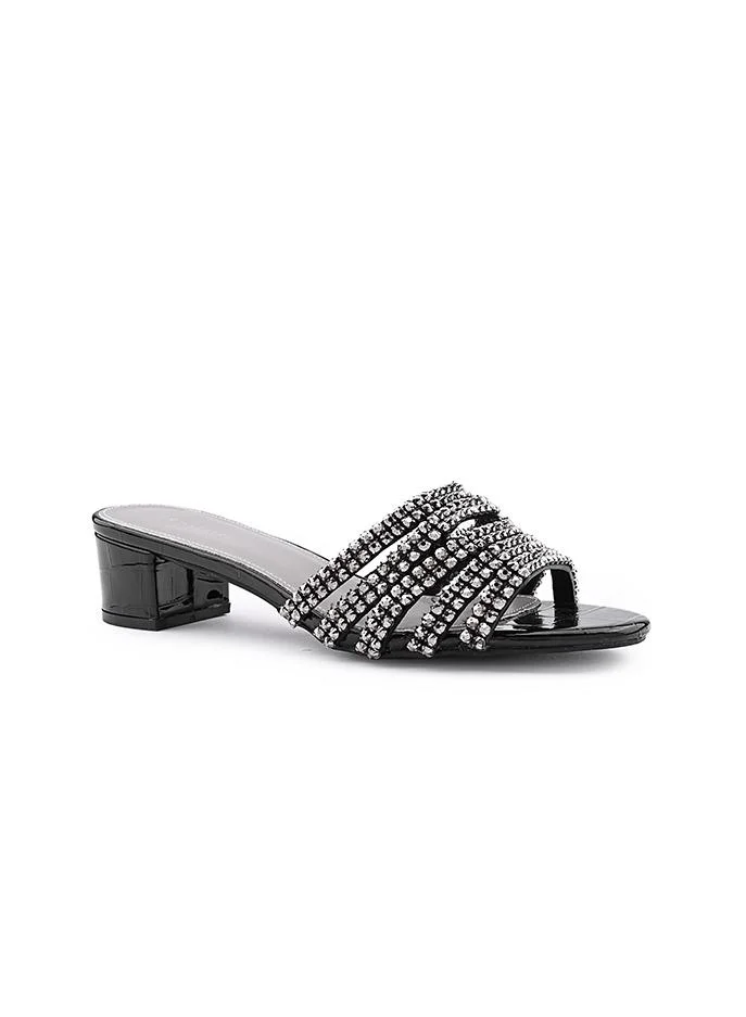 أيقون Crystal heel slipper with a refined finish.