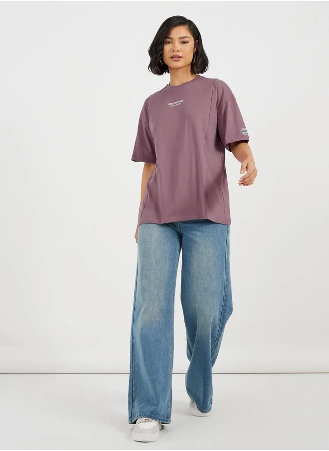 ستايلي Styli Oversized T-Shirt with Print and Badge Detail