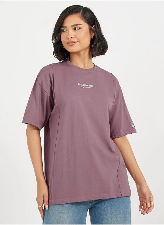 ستايلي Styli Oversized T-Shirt with Print and Badge Detail