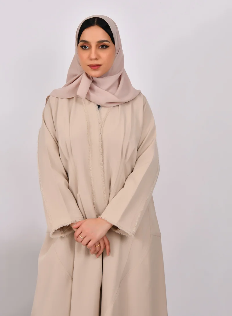 HAWRAA ABAYA Beige wrap abaya with tassels on the edges of the abaya and sleeves, and soft front and back pleats