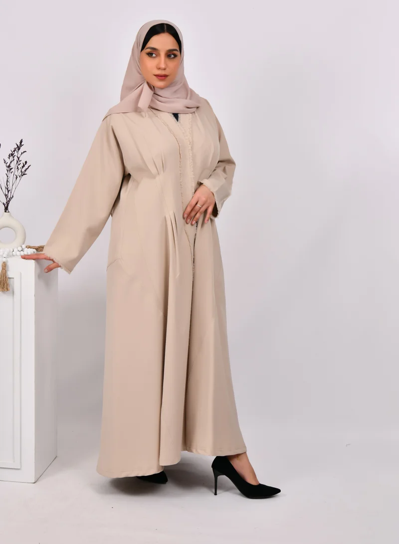 HAWRAA ABAYA Beige wrap abaya with tassels on the edges of the abaya and sleeves, and soft front and back pleats