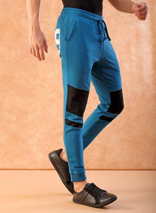 ذا انديان كراج كو Men Slim Fit Solid Mid-Rise Stretchable Knitted Jogger Trousers