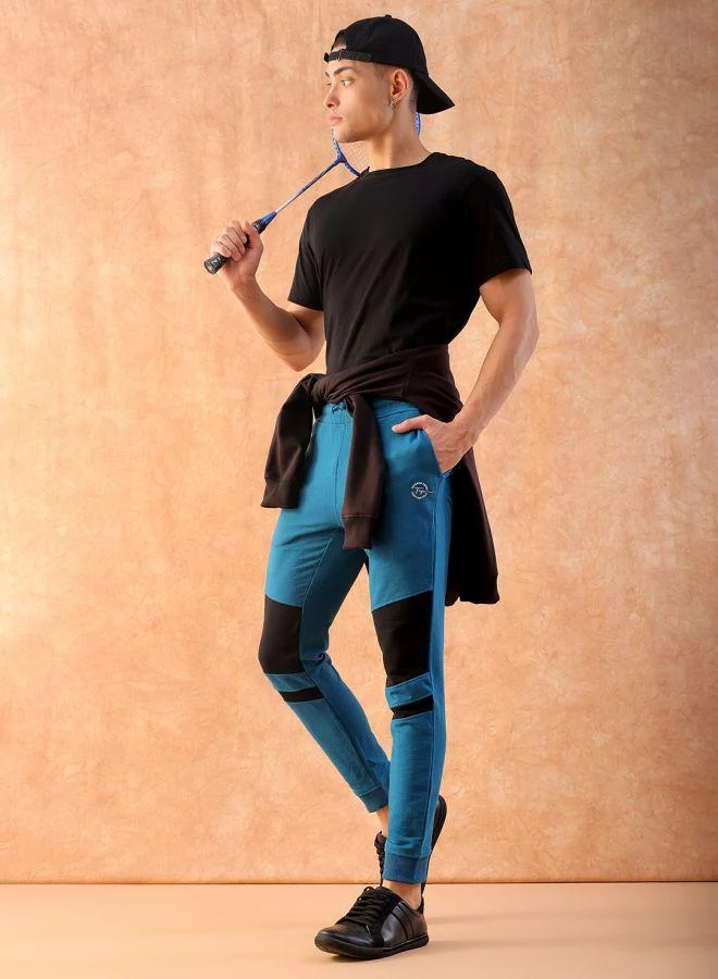 ذا انديان كراج كو Men Slim Fit Solid Mid-Rise Stretchable Knitted Jogger Trousers