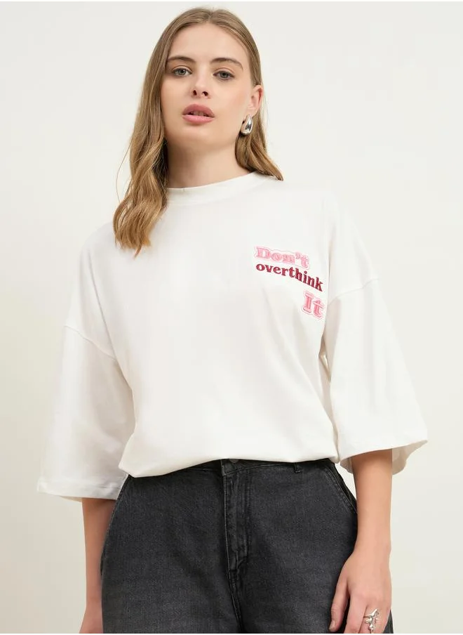 Styli Styli Women Cream Slogan Embroidered Dropped Shoulder Oversized T-Shirt