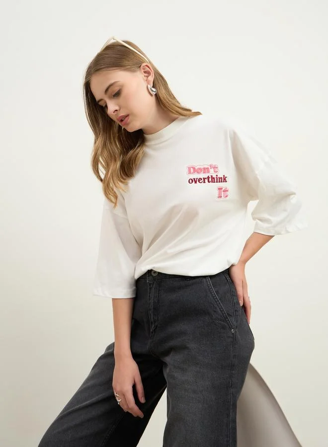Styli Women Cream Slogan Embroidered Dropped Shoulder Oversized T-Shirt