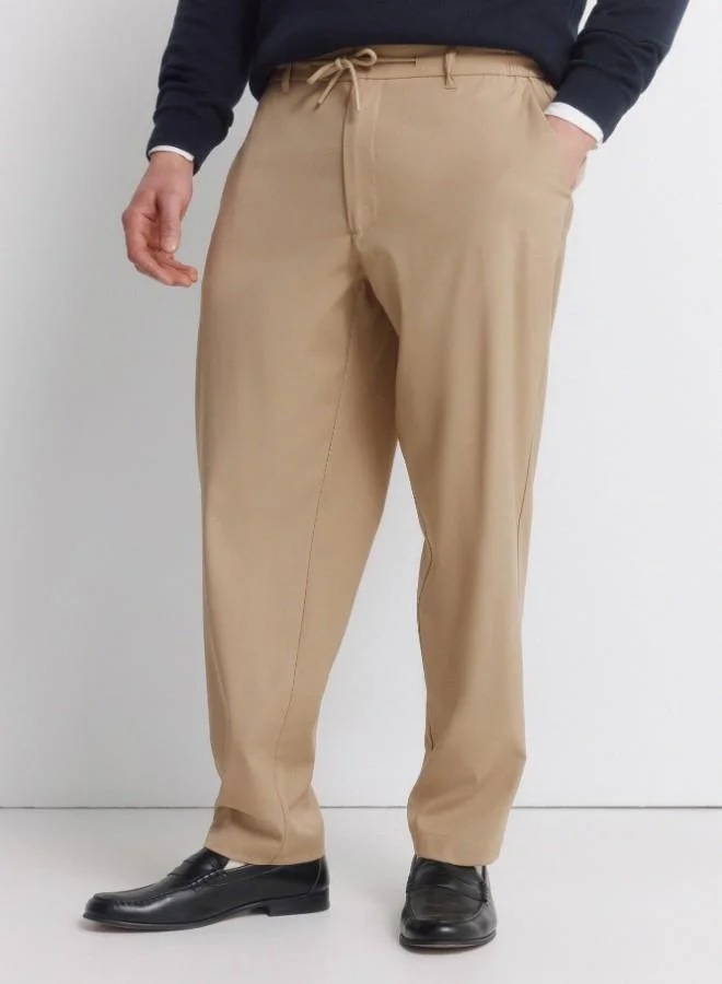 Springfield  Trousers in fluid-look and soft-touch fabric, very comfortable. Elasticated waistband at the back, with an internal drawstring for a better fit. Front seam pockets. Front pleats. Relaxed fit. for Men | Best Price UAE