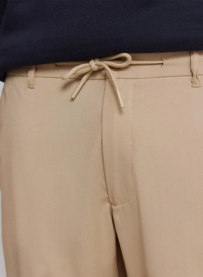 Springfield  Trousers in fluid-look and soft-touch fabric, very comfortable. Elasticated waistband at the back, with an internal drawstring for a better fit. Front seam pockets. Front pleats. Relaxed fit. for Men | Best Price UAE