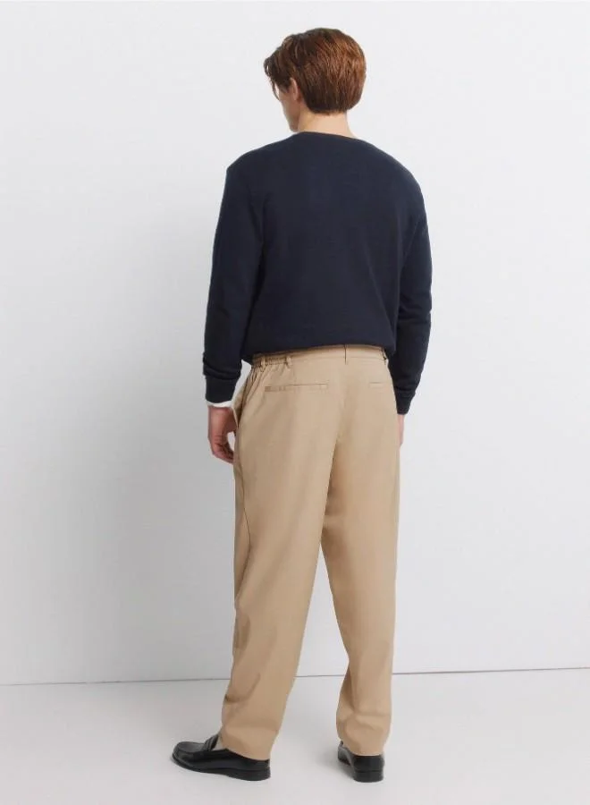 Springfield  Trousers in fluid-look and soft-touch fabric, very comfortable. Elasticated waistband at the back, with an internal drawstring for a better fit. Front seam pockets. Front pleats. Relaxed fit. for Men | Best Price UAE