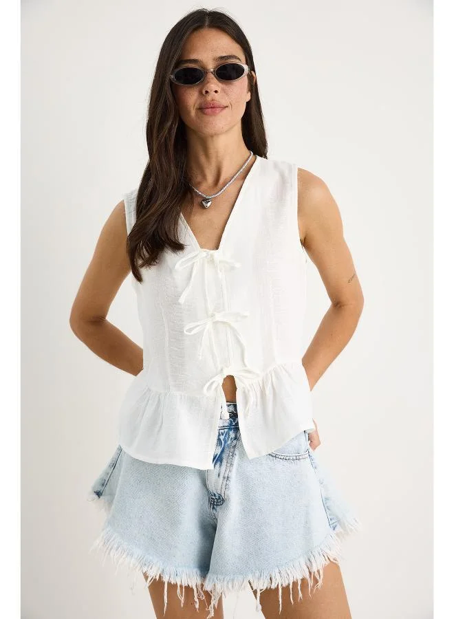 Ginger Bow Tie Up Detail Peplum Top