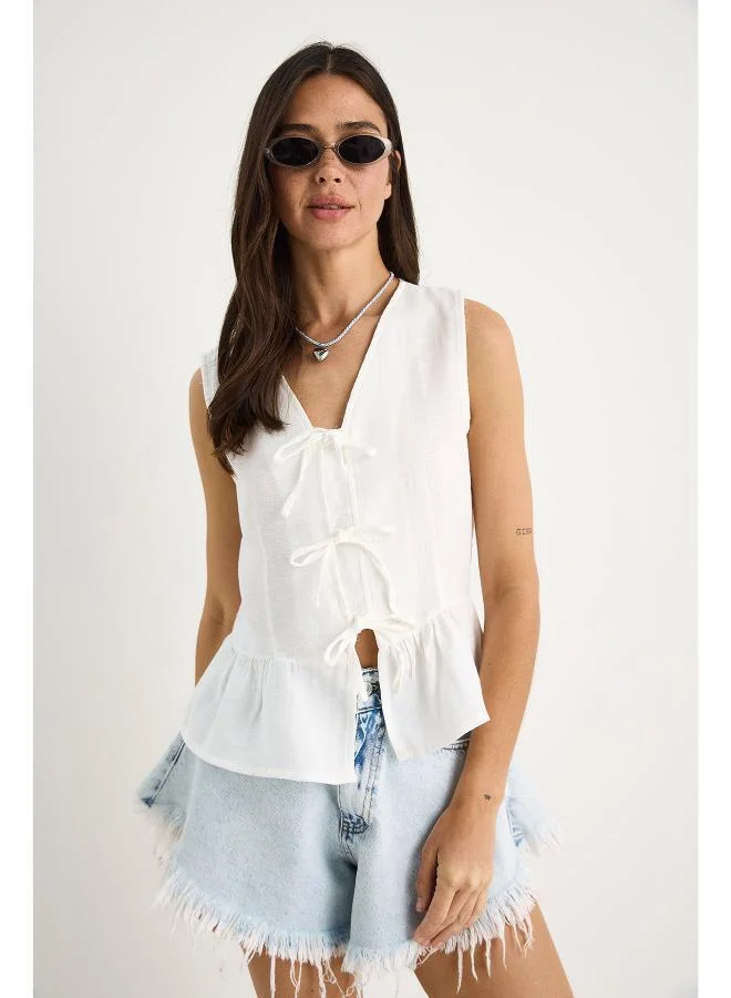 Ginger Bow Tie Up Detail Peplum Top