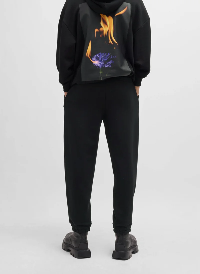 HUGO Relaxed-fit tracksuit bottoms with logo and slogans