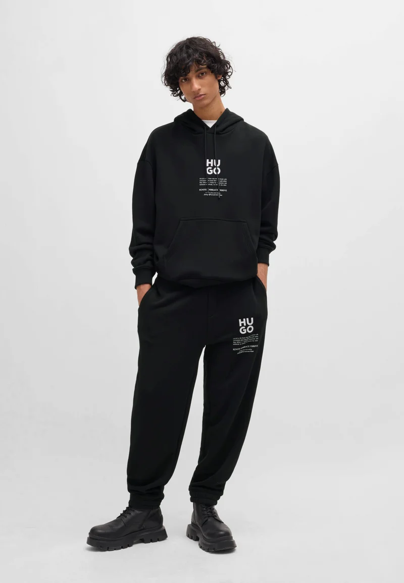 HUGO Black Relaxed-fit tracksuit bottoms with logo and slogans for Men | Best Price UAE