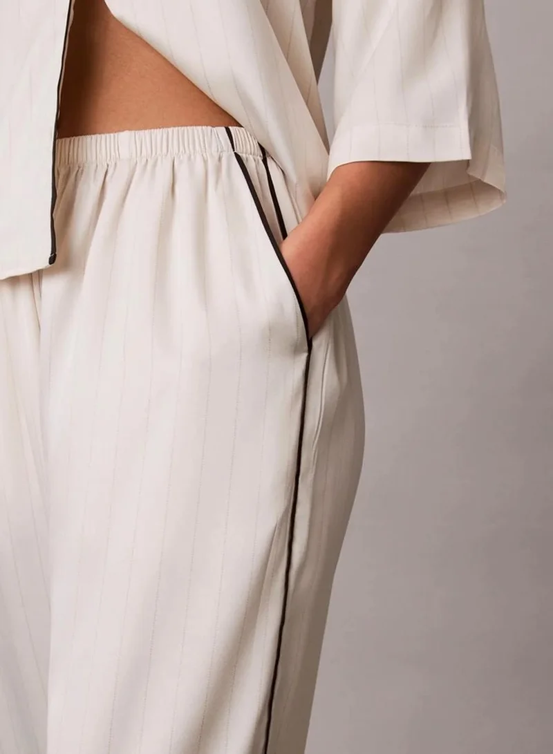 Calvin Klein DOTTED LOGO PINSTRIPE IVORY Satin Sheen Pants for Women | Best Price UAE
