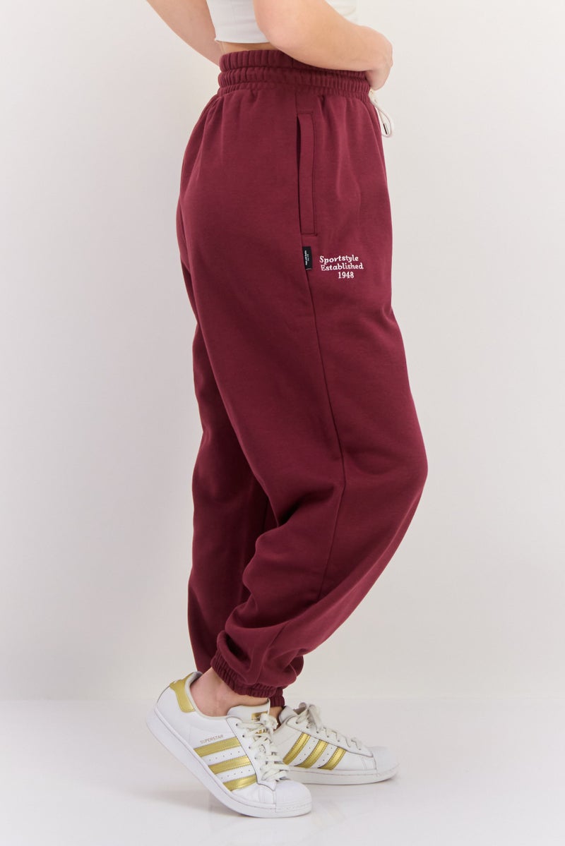 PUMA سروال رياضي خارجي للنساء بقصة مريحة مع حبل سحب، مارون - Image 2