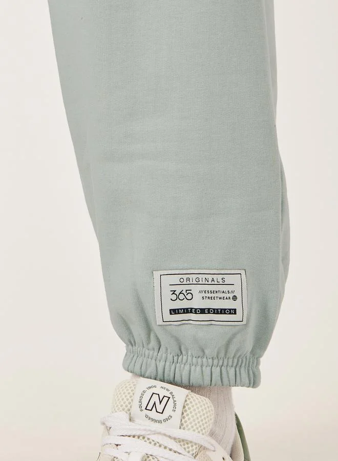Styli Mid Rise Relaxed Fit Joggers with Badge Detail