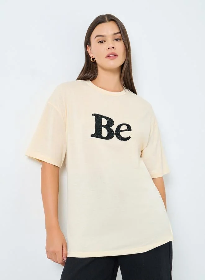 Styli Styli Beige Oversized Embellished Slogan T-Shirt