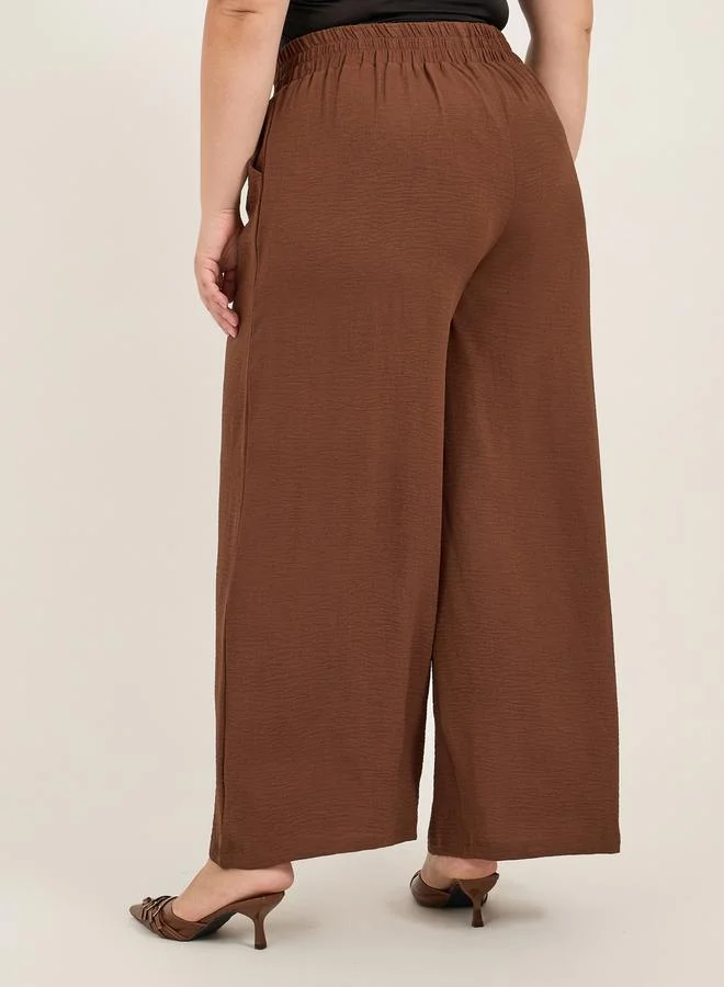 Styli Plus Size Textured Wide Leg Trousers with Chain Buckle Detail