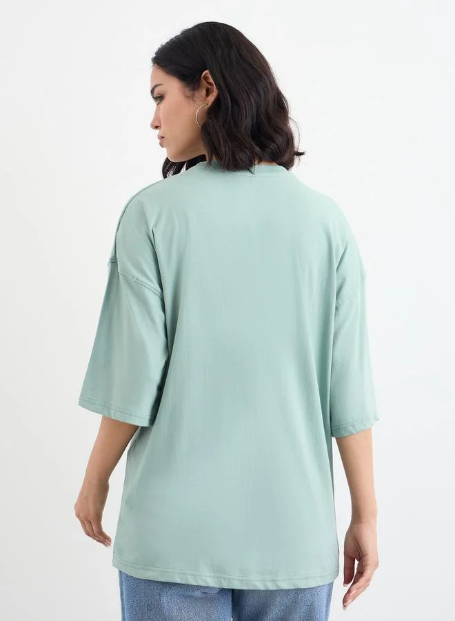 Styli Styli Women Green Slogan Print Dropped Shoulder Oversized T-Shirt