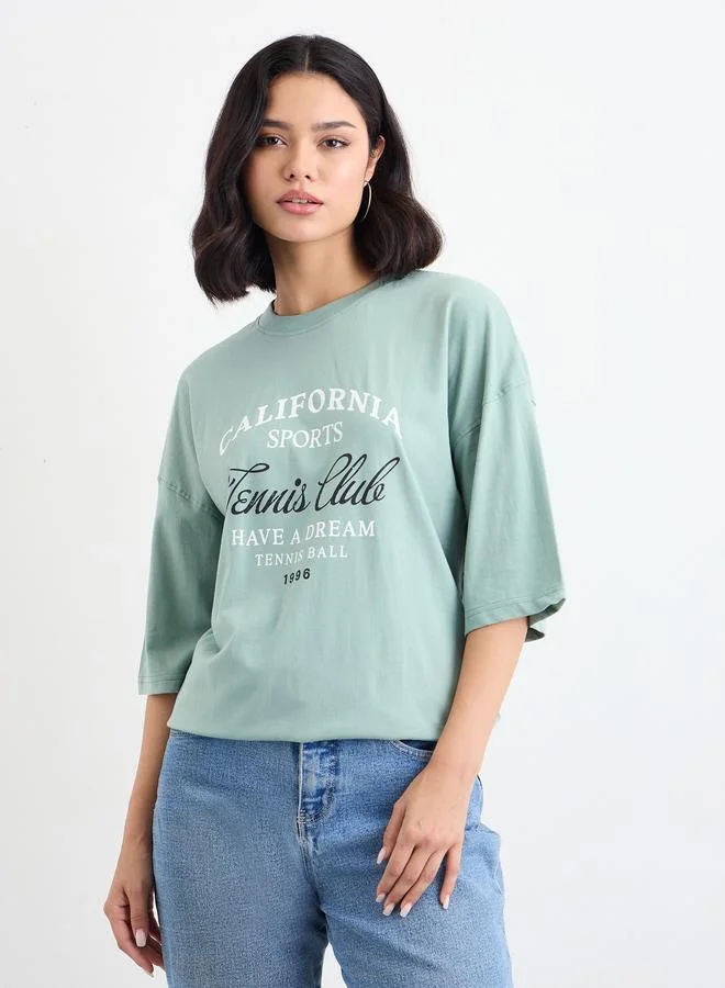 Styli Women Green Slogan Print Dropped Shoulder Oversized T-Shirt