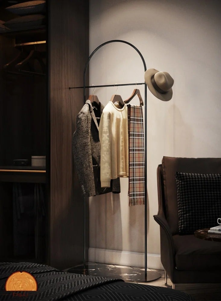 This elegant and simple metal clothes rack features a black marble-patterned wood base for hanging clothes, hats, and bags.