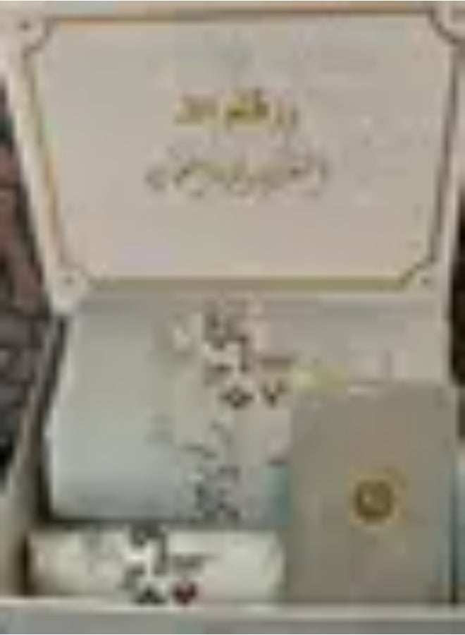 Elegant women's prayer set box: prayer gown and mat, with a Quran and prayer beads.