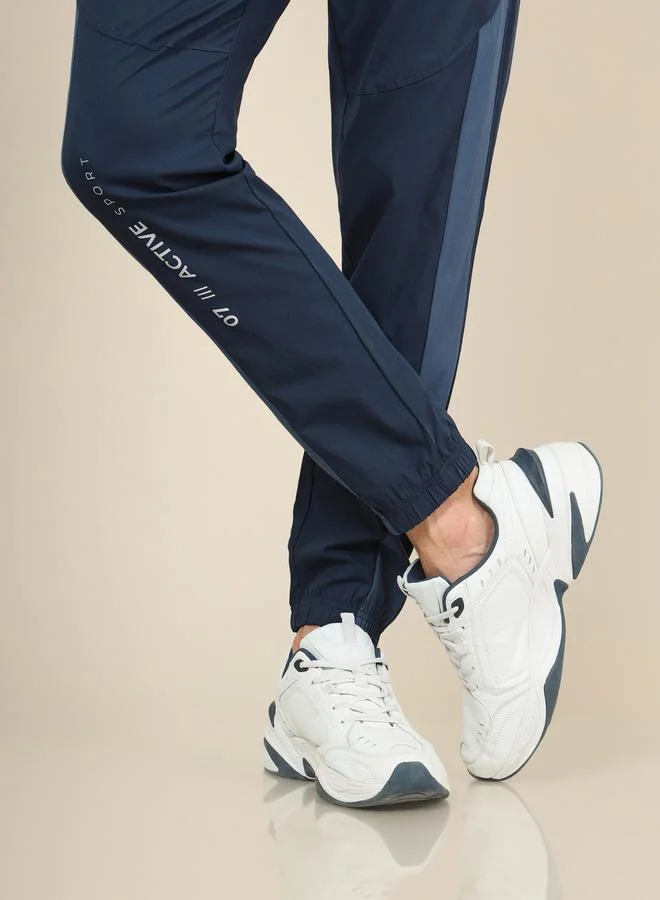 تكنوسبورت Solid Woven Stretch Track Pants with  Elastic Cuff by Styli