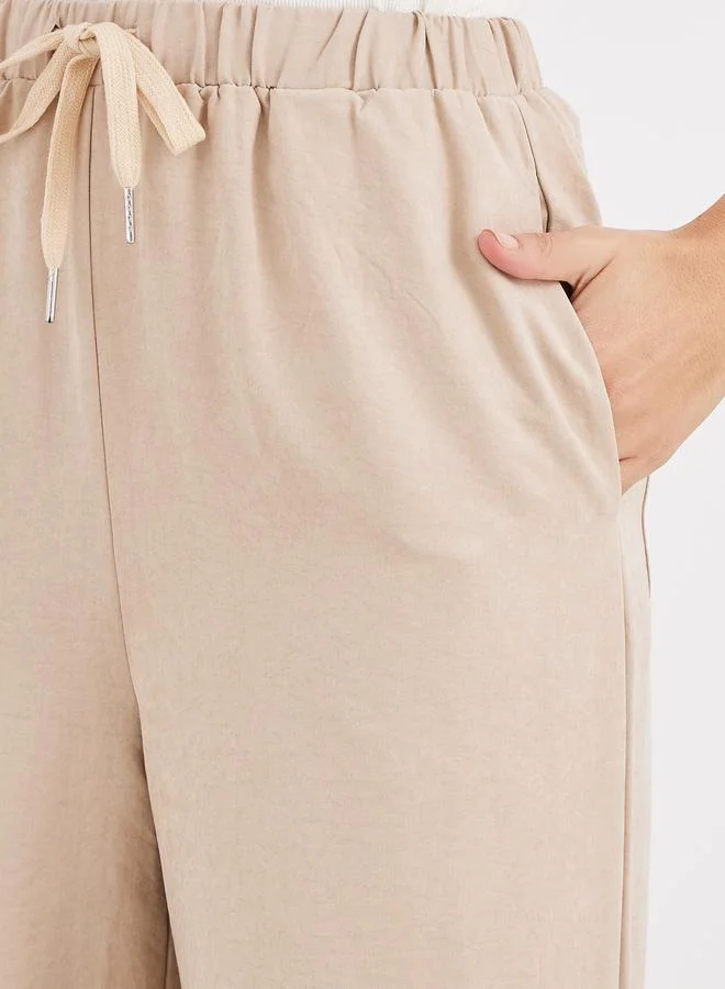 Styli Women Cream Solid Drawstring Waist Wide Leg Pants