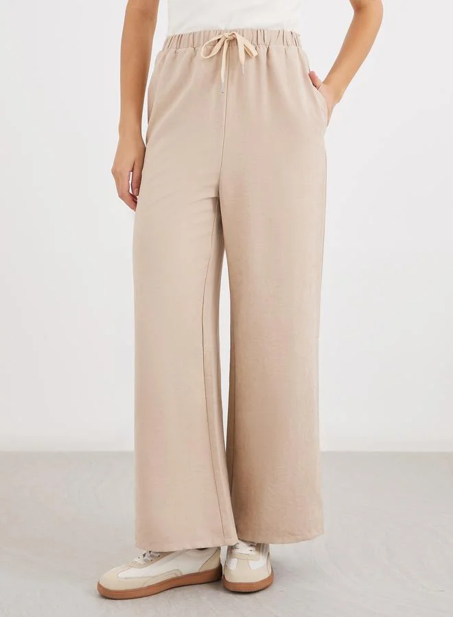 ستايلي Styli Women Cream Solid Drawstring Waist Wide Leg Pants