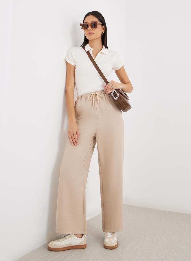 Styli Women Cream Solid Drawstring Waist Wide Leg Pants - Image 1