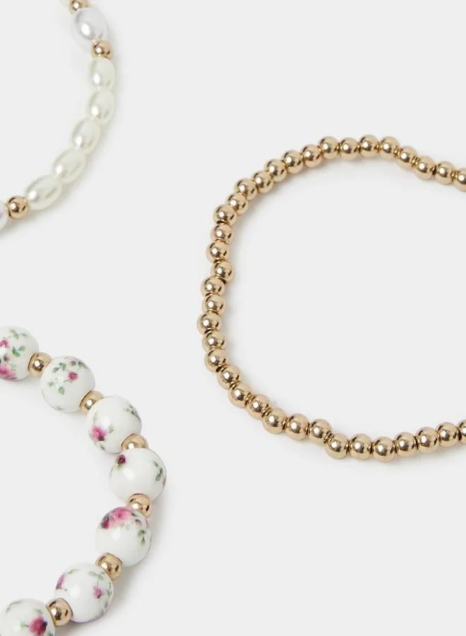 Styli  Pack of 3 - Gold Tone and Pearl Beaded Bracelets with Bow Charm for Women | Best Price UAE
