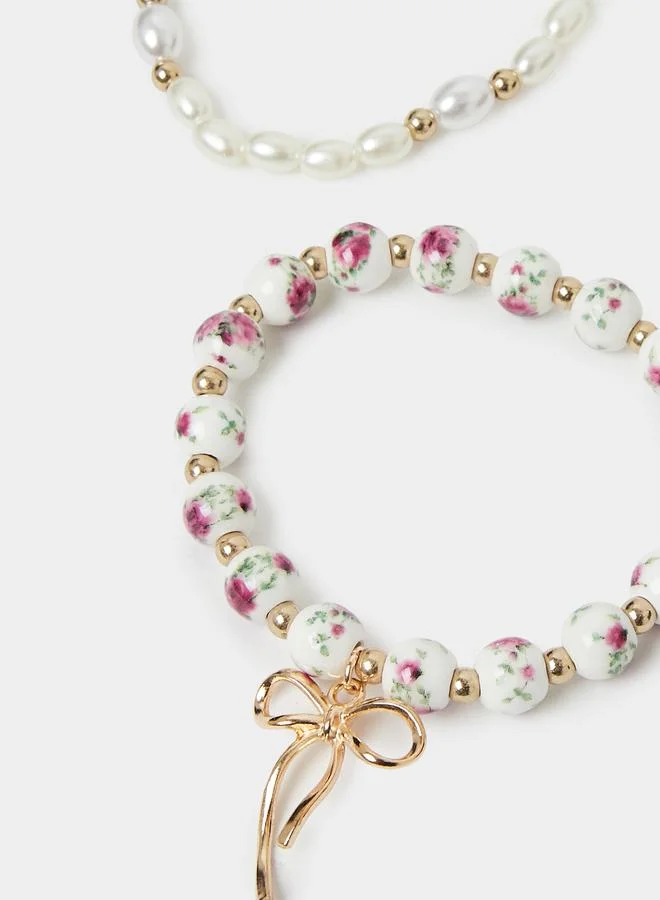 Styli  Pack of 3 - Gold Tone and Pearl Beaded Bracelets with Bow Charm for Women | Best Price UAE