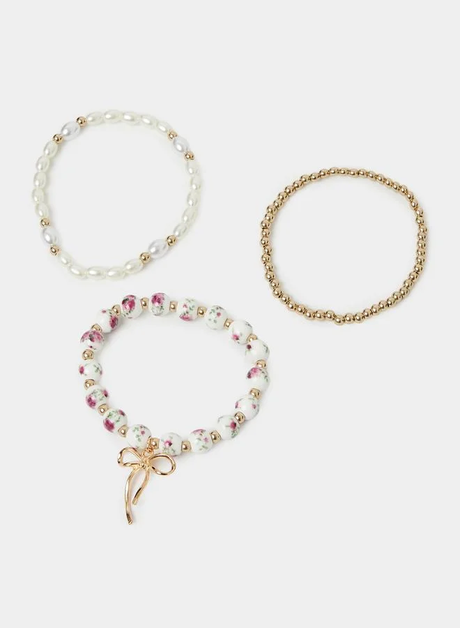 ستايلي Pack of 3 - Gold Tone and Pearl Beaded Bracelets with Bow Charm