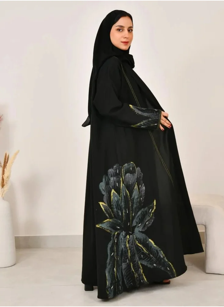 lamha abaya Black cloche abaya with floral print on the sides of the abaya and sleeves with prominent yellow stitching