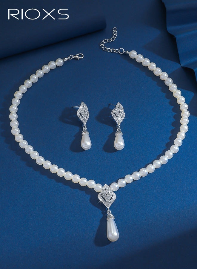 ريوكس مجموعة مجوهرات من اللؤلؤ مكونة من قطعتين للنساء، قلادات وأقراط أنيقة من اللؤلؤ والكريستال الفضي، قلادة وسوار زفاف أنيقان من اللؤلؤ الصناعي، قلادة كريستالية للعروس، إكسسوارات لعيد الحب، الزفاف، الأزياء، حفلات التخرج، الحفلات - Image 4