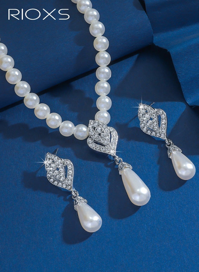 ريوكس مجموعة مجوهرات من اللؤلؤ مكونة من قطعتين للنساء، قلادات وأقراط أنيقة من اللؤلؤ والكريستال الفضي، قلادة وسوار زفاف أنيقان من اللؤلؤ الصناعي، قلادة كريستالية للعروس، إكسسوارات لعيد الحب، الزفاف، الأزياء، حفلات التخرج، الحفلات - Image 3