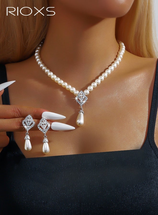 ريوكس مجموعة مجوهرات من اللؤلؤ مكونة من قطعتين للنساء، قلادات وأقراط أنيقة من اللؤلؤ والكريستال الفضي، قلادة وسوار زفاف أنيقان من اللؤلؤ الصناعي، قلادة كريستالية للعروس، إكسسوارات لعيد الحب، الزفاف، الأزياء، حفلات التخرج، الحفلات - Image 1
