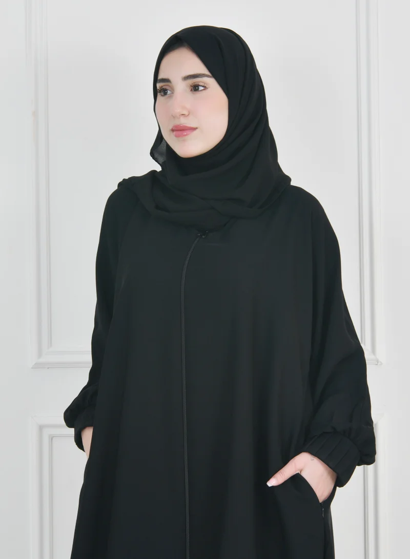 HAWRAA ABAYA Black zippered abaya with narrow pleated sleeves and hidden zippered pockets
