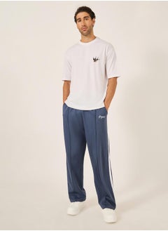 Styli Oversized Wide Tuck Fleece Joggers with Side Stripe and Print Detail  - Image 1
