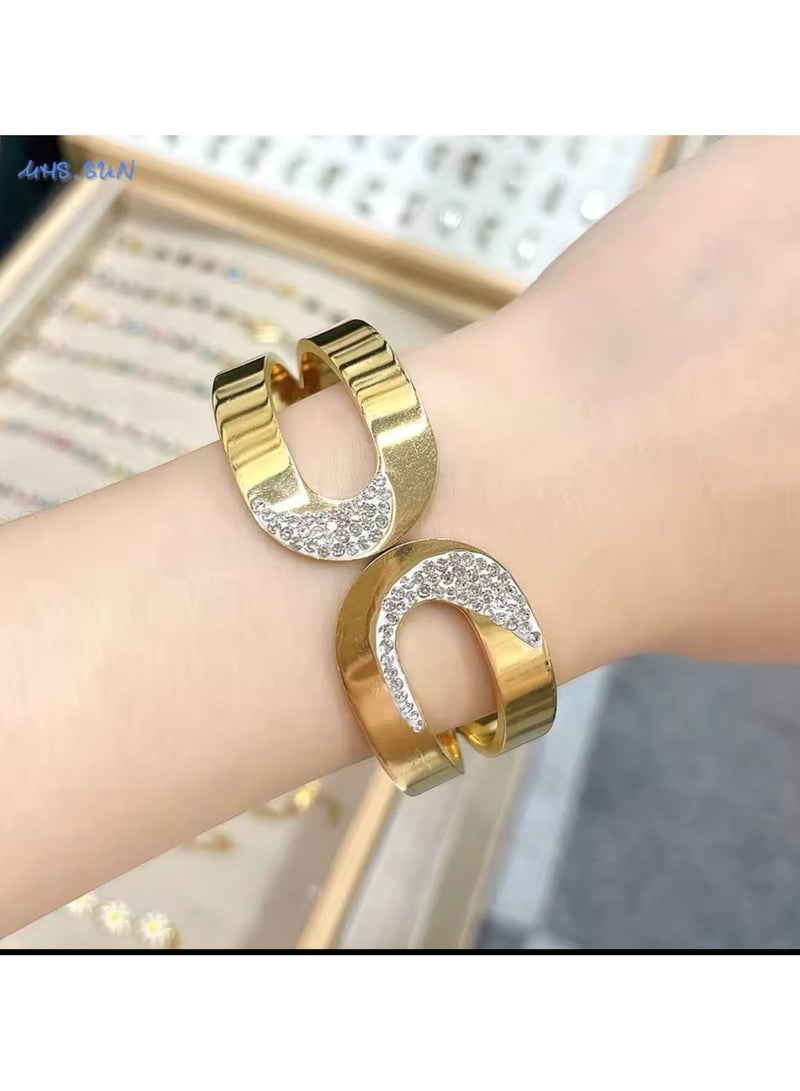 Wide Gold Stainless Steel Bracelet with a modern and elegant design, adorned with shiny rhinestones that add a touch of luxury and allure to your wrist. Flexible and comfortable for daily wear and special occasions.  - Image 1