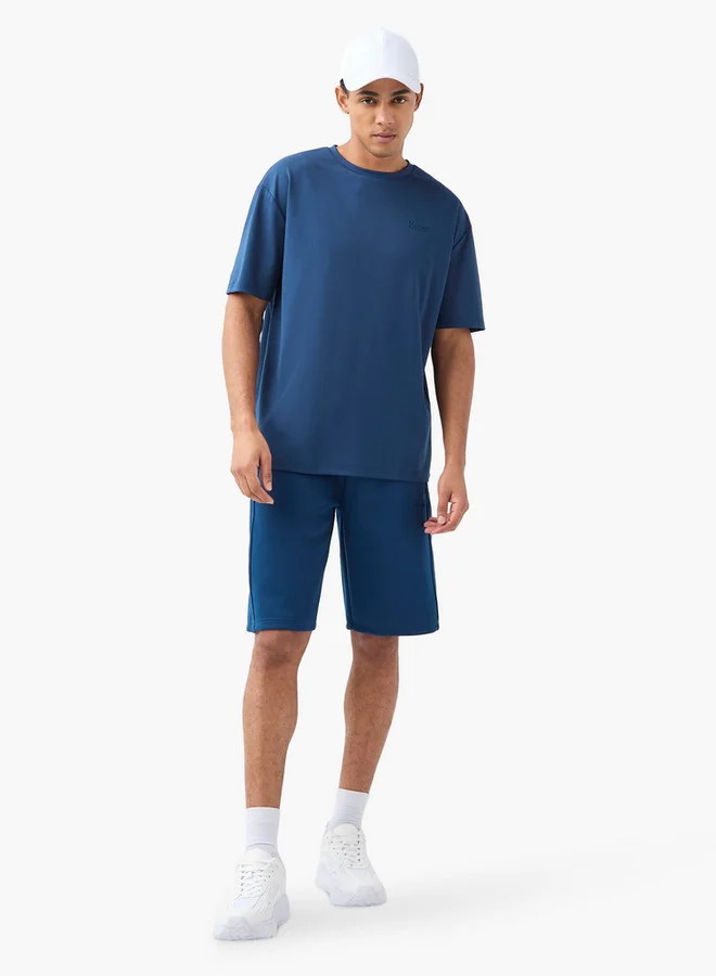 كابا تيشيرت بياقة ضيّقة وأكمام قصيرة وشعار من كابا