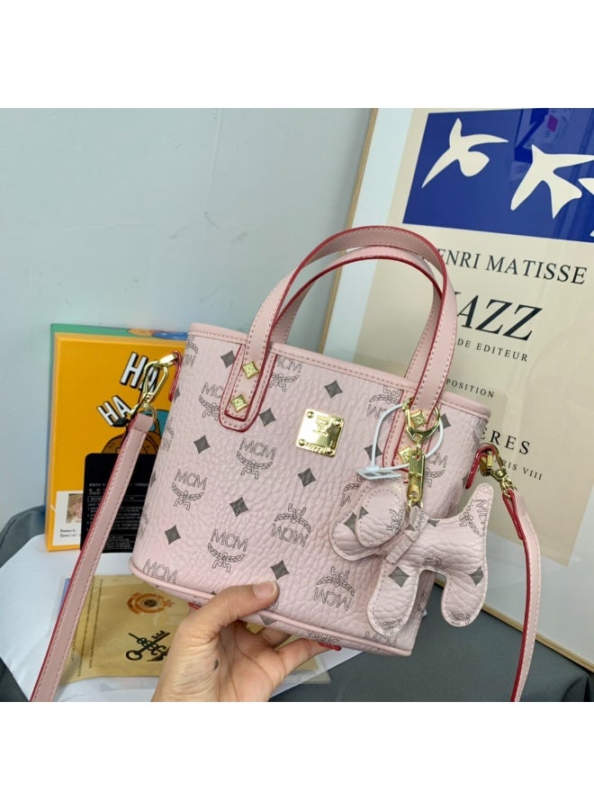 MCM Pink Monogrammed Mini Bucket Tote Bag with Top Handle, Crossbody Strap and Dog Charm