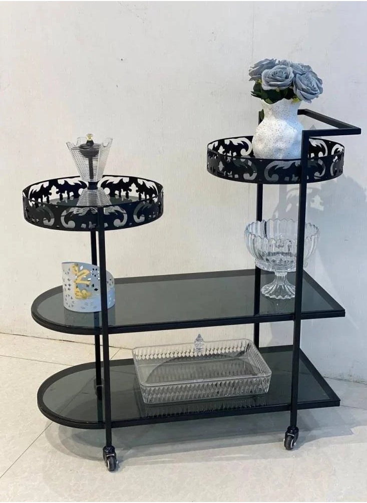 fan baytk - "A stylish three-tier serving cart made of black iron with glass, the third tier is divided into two circular pieces. The cart is 87 cm high, 90 cm long and 40 cm wide. Its circular design adds an aesthetic and modern touch, making it ideal for serving food and drinks at parties and special occasions." - Image 1