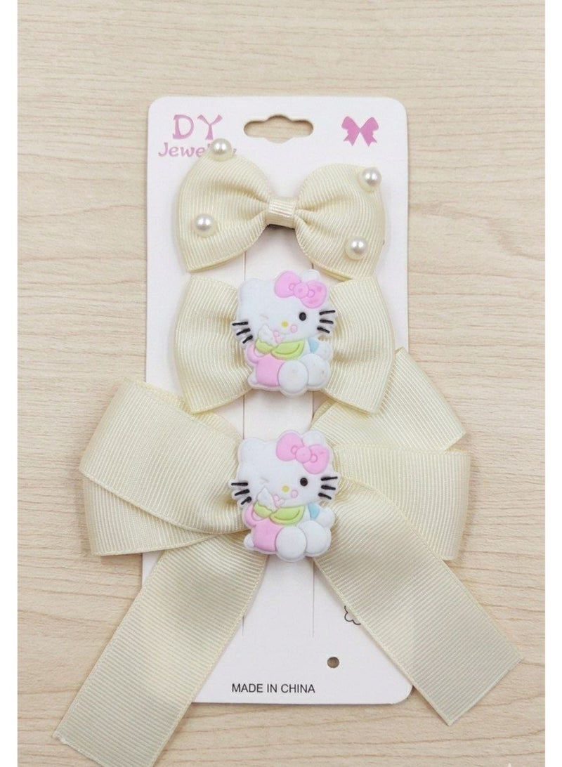 A set of 3 off-white anime-themed hair clips for children.