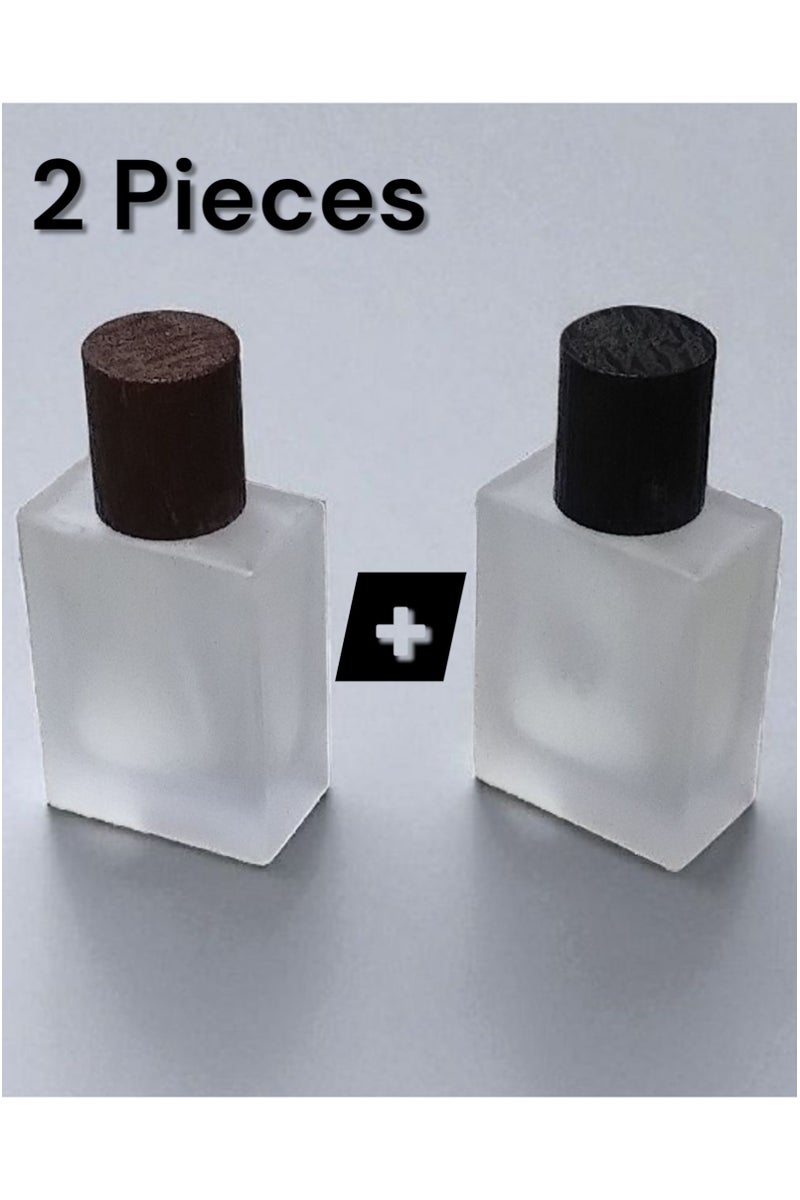 2 pieces of empty refillable spray perfume bottles so you can fill your favorite perfume and carry it with you at any time. The color of the glass is not transparent and frosty. The bottle cap is in the shape of a piece of wood. The color of the cap is brown and the other bottle is black. It is ideal in size and easy to carry and move. Put it in your pocket, bag, or even in a small evening bag for wives. It is a bottle designed for the bag. It does not take up space or room due to its suitable size. It is useful for travel, work, trips, wedding parties, or holidays. The bottle capacity is 30 ml. - Image 1
