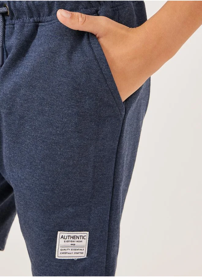 ستايلي Solid Drawstring Waist Shorts with Badge Detail
