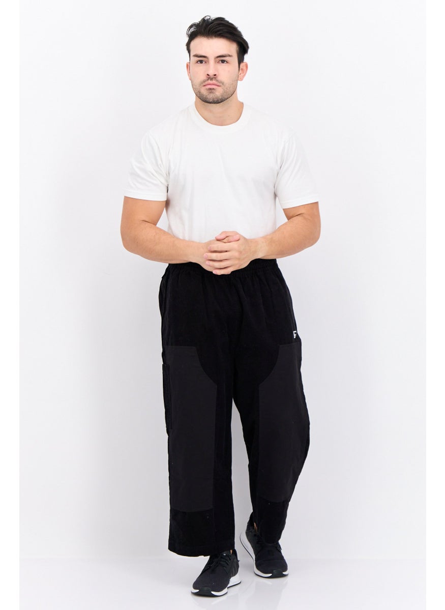 PUMA Men Sportswear Fit Brand Logo Outdoor Sweatpants, Black  - Image 4