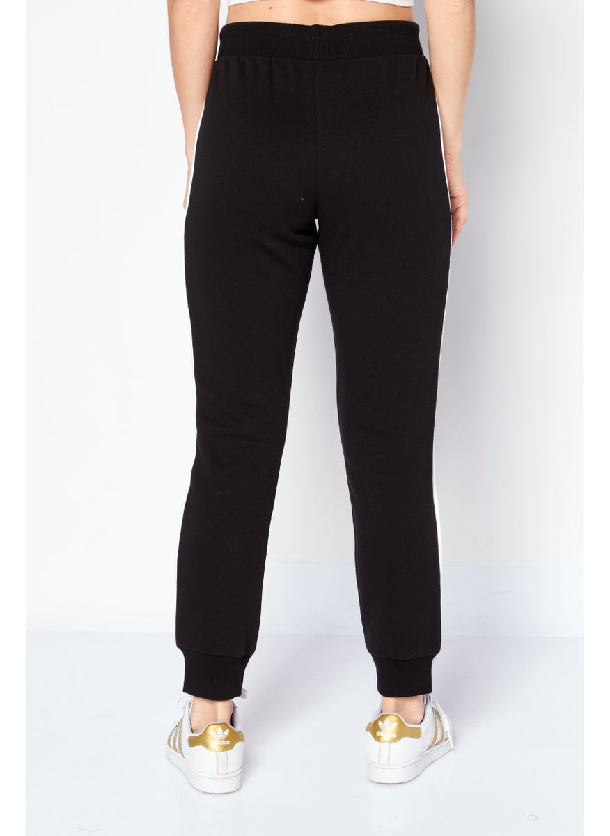 PUMA - Women Slim Fit T7 Drawstring Training Sweatpants, Black - Image 1