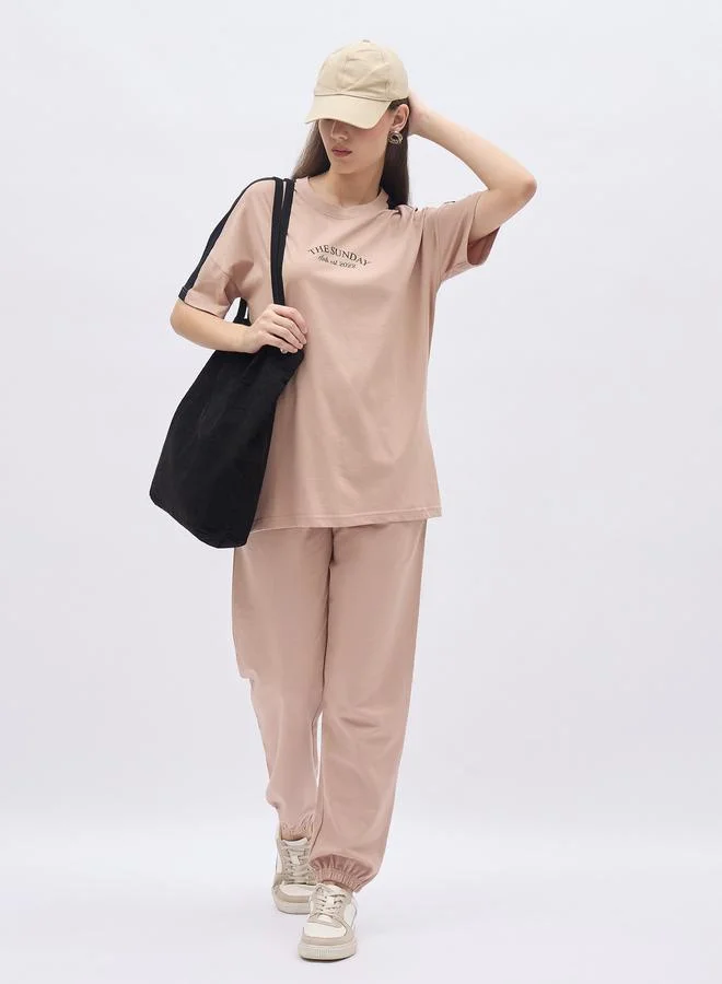 Styli Styli Beige Oversized Slogan T-Shirt and Cuffed Joggers Set