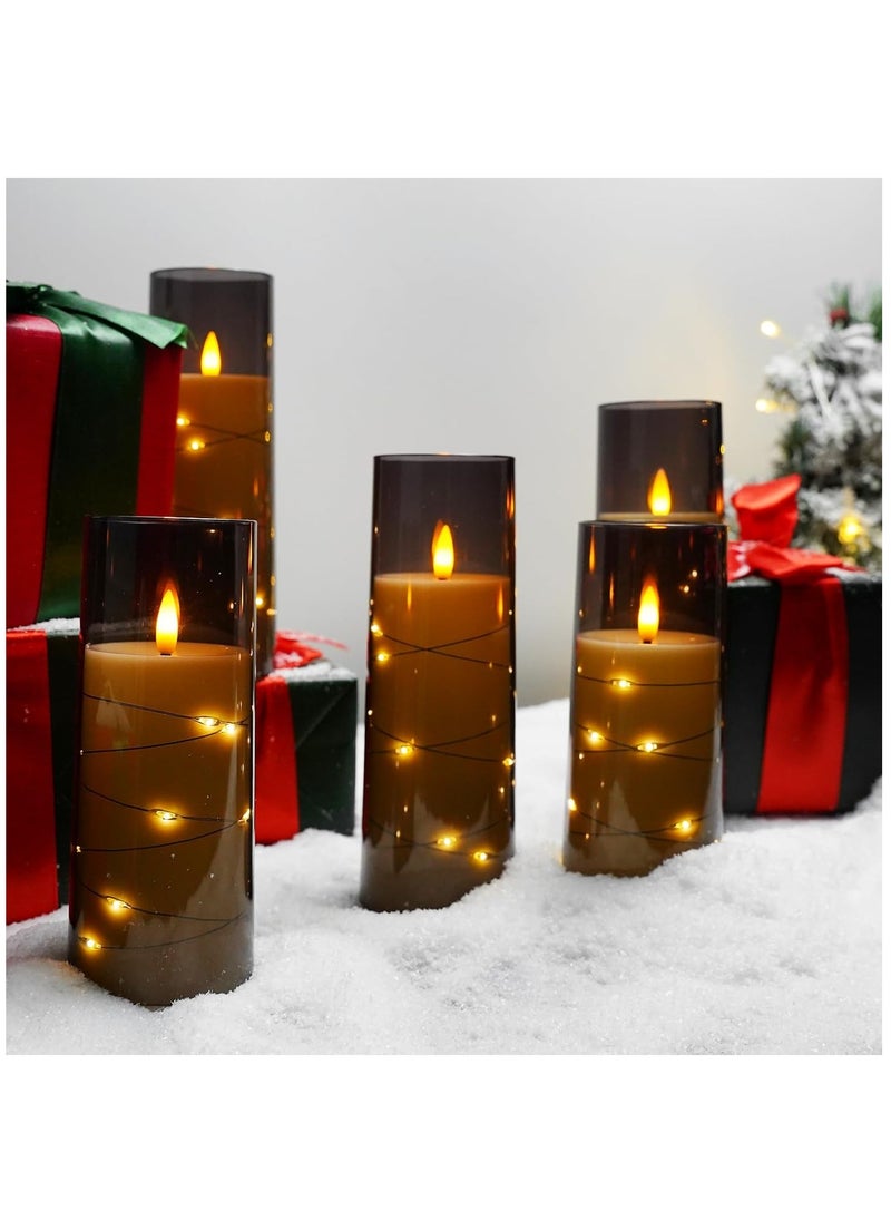 Battery operated pillar candles with 3D teardrop shaped wicks and embedded starlight strings featuring a real wax design a remote control and timer function in a set of 5 LED candles.